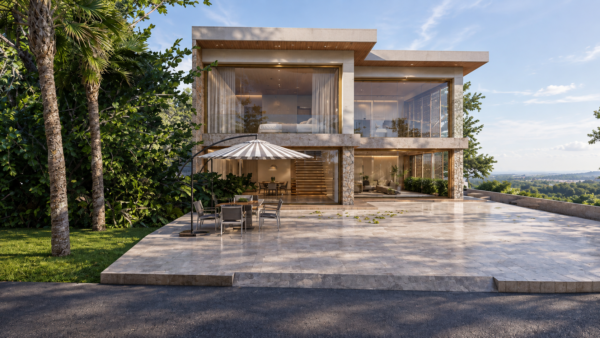 Renderização arquitetônica de edifício contemporâneo de dois pavimentos com revestimento em mármore travertino e pedra natural, evidenciando grandes vãos envidraçados com esquadrias douradas. Em primeiro plano, um pátio externo pavimentado em pedra clara com conjunto de mesa, cadeiras e ombrelone listrado, cercado por densa vegetação tropical com palmeiras e vista para o horizonte.